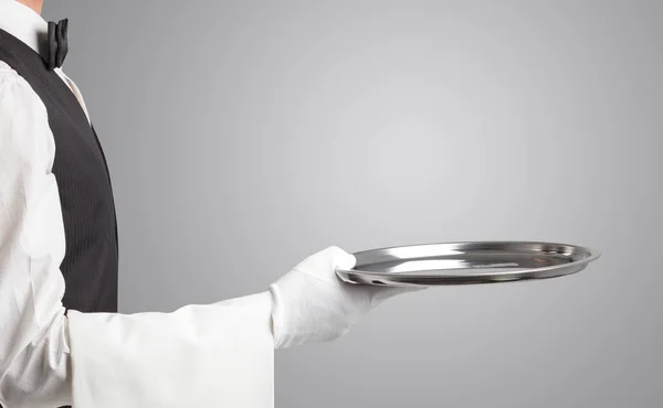 Waiter serving with white gloves and steel tray