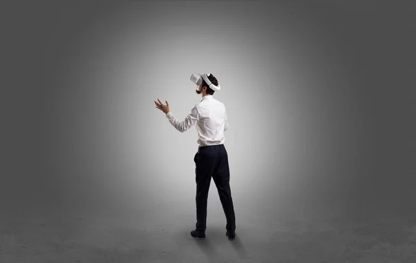 Businessman in an empty room with vr glasses — Stock Photo, Image