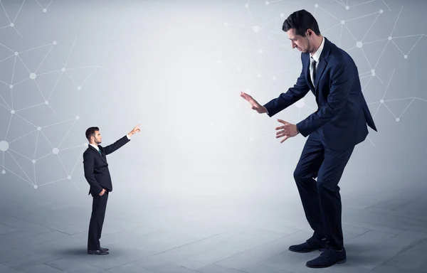 Small man aiming at a big man with network concept — Stock Photo, Image