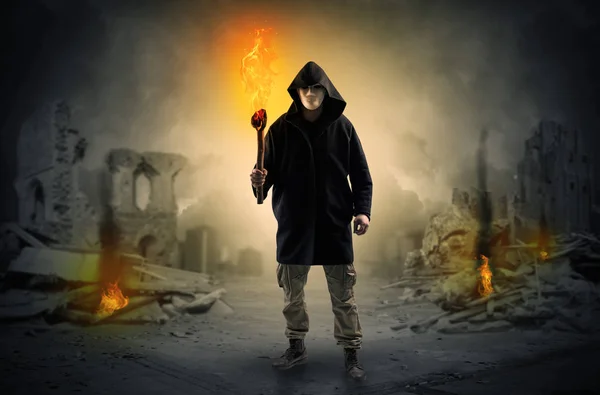 Man coming with burning flambeau at a catastrophe scene concept