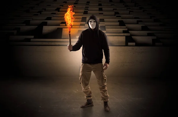 Man coming with burning flambeau from the maze concept — Stock Photo, Image