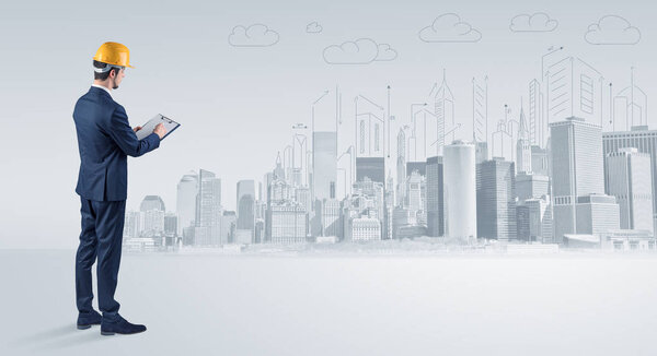 Architect standing and  replanning a city panorama