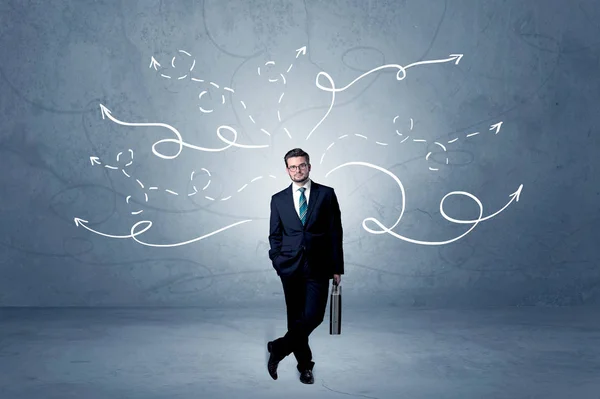 Businessman standing with winding arrows around — Stock Photo, Image