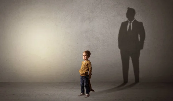 Little boy with businessman shadow Royalty Free Stock Photos