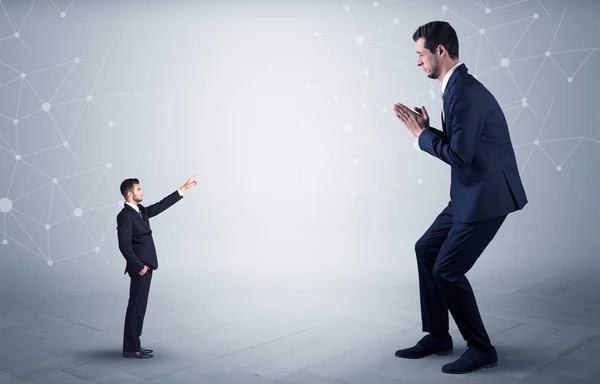 Small man aiming at a big man with network concept — Stock Photo, Image