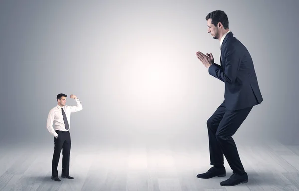 Giant businessman scared of small businessman — Stock Photo, Image