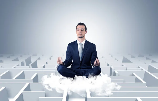 Businessman meditates on a cloud with maze concept — Stock Photo, Image