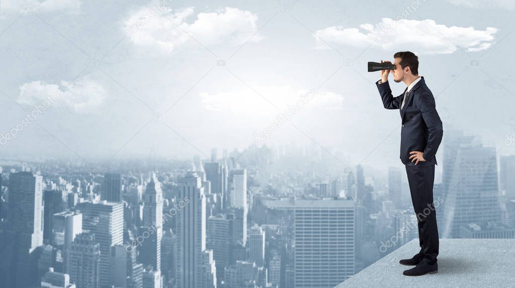 Man looking forward from the top of a skyscraper