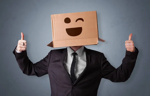 Funny man smiling with cardboard box head — Stock Photo, Image