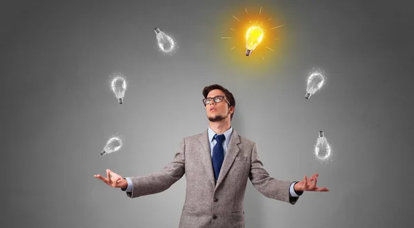 Happy person juggle with bulbs — Stock Photo, Image