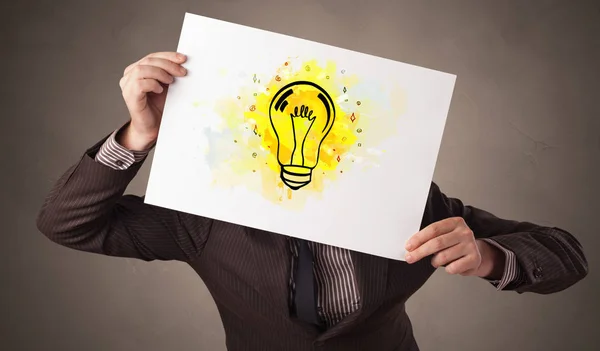 Person holding a paper with colorful bulb concept — Stock Photo, Image