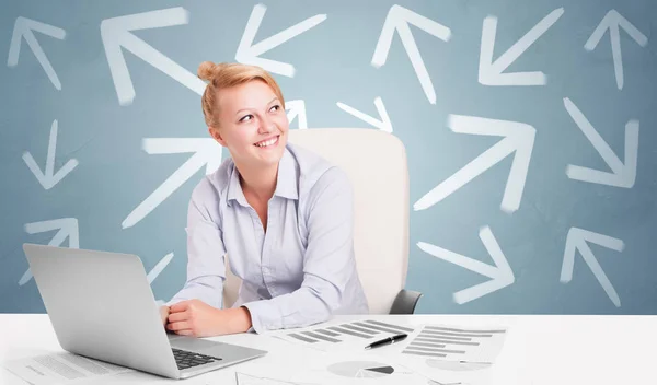 Business person sitting at desk with direction concept — Stock Photo, Image