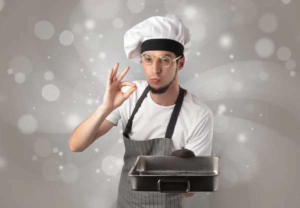 Male cook with shiny grey wallpaper