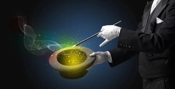 Illusionist hand making trick with wand — Stock Photo, Image