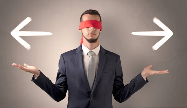 Covered eye businessman choosing direction — Stock Photo, Image