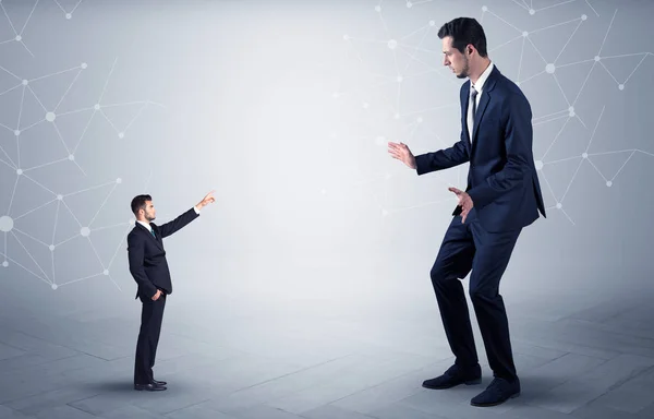 Small man aiming at a big man with network concept — Stock Photo, Image