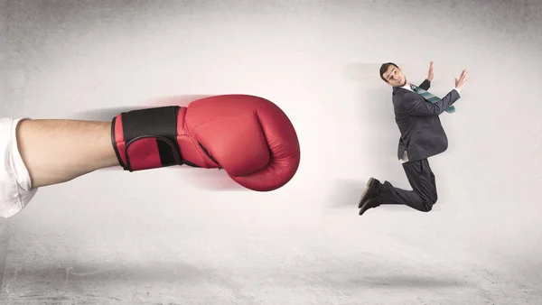 Businessman gets fired by a huge boxing hand — Stock Photo, Image