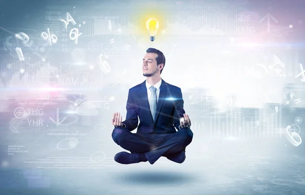 Businessman meditates with enlightenment concept — Stock Photo, Image