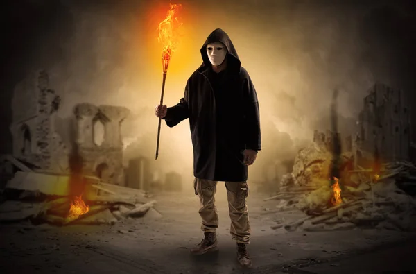 Man coming with burning flambeau at a catastrophe scene concept