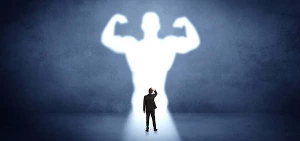 Businessman standing in front of a strong hero vision — Stock Photo, Image
