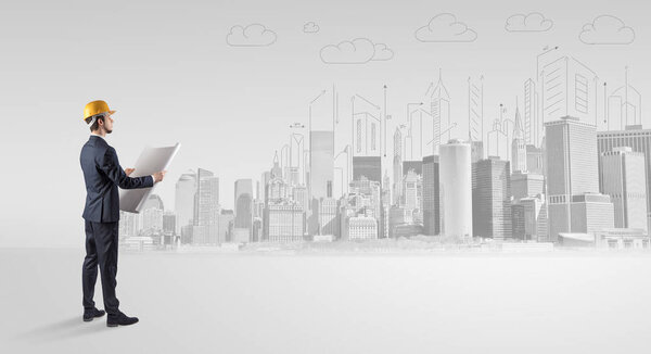 Young supervisor architect standing and replanning a big city panorama