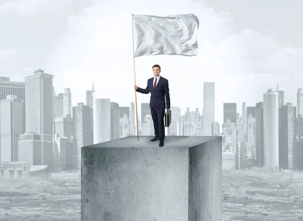 Businessman on the top of the city holding flag