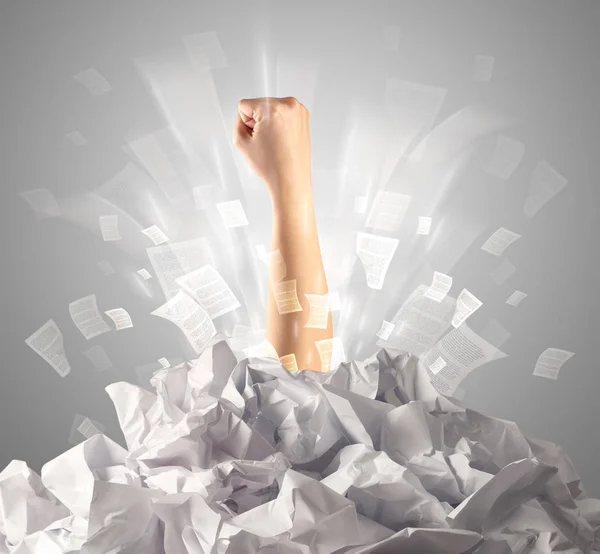 Hand coming out from paper pile — Stock Photo, Image