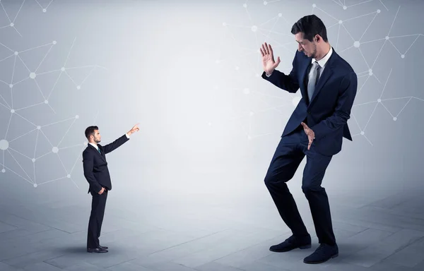 Small man aiming at a big man with network concept — Stock Photo, Image