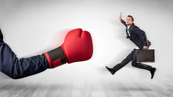 Red boxing glove knocks out little businessman