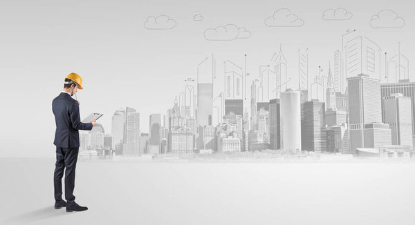 Architect standing and  replanning a city panorama