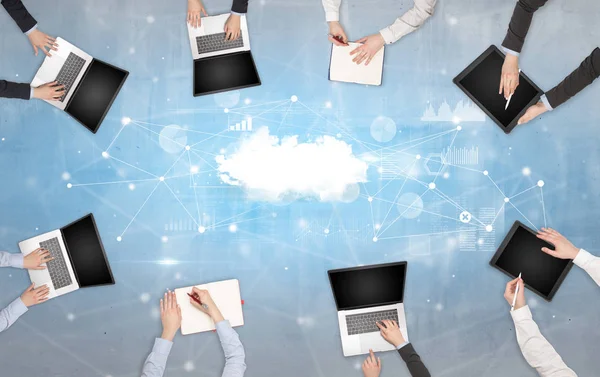 Grupo de pessoas com dispositivos em mãos trabalhando em laptops e tablets com conceito de trabalho em equipe online — Fotografia de Stock