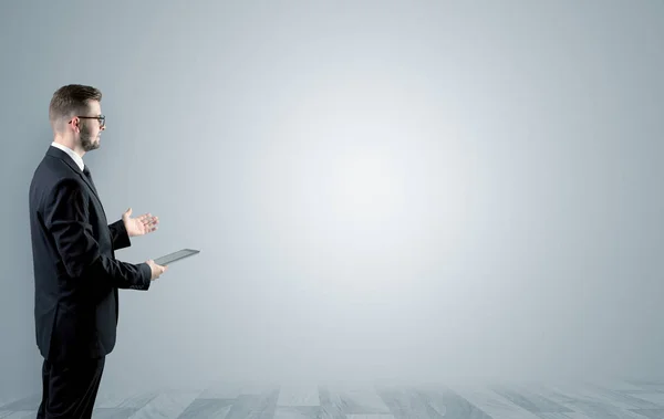 Businessman standing in an empty space — Stock Photo, Image