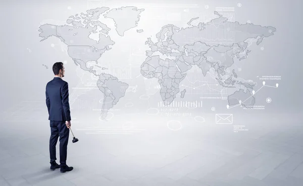 Man looking at map with objects in his hand — Stock Photo, Image