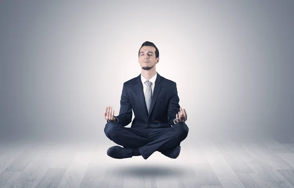 Businessman meditates in an empty space concept — Stock Photo, Image