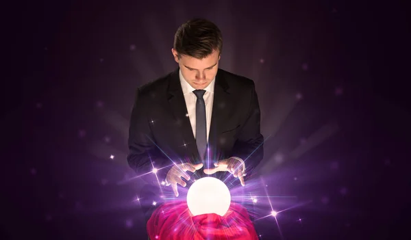 Businessman sitting with crystal ball in action — Stock Photo, Image