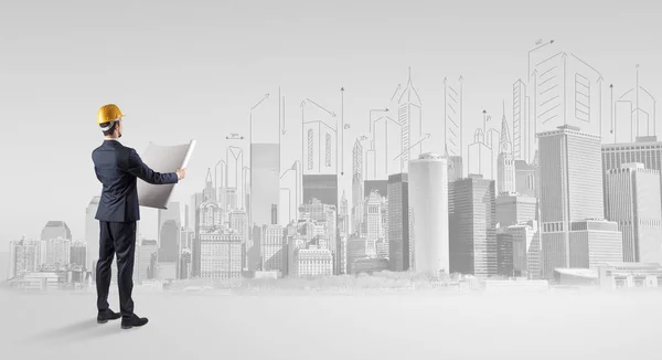 Architect standing and  replanning a city panorama — Stock Photo, Image