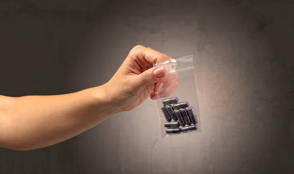 Giving drugs in plastic bag — Stock Photo, Image