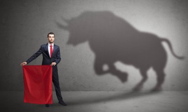 Businessman with bull shadow and toreador concept clipart