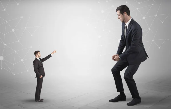 Small man aiming at a big man with network concept — Stock Photo, Image