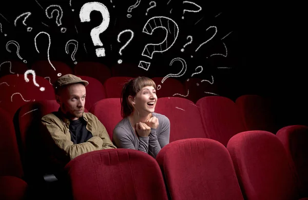 Couple in cinema with questions