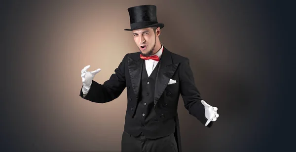 Magician holds something invisible Royalty Free Stock Images