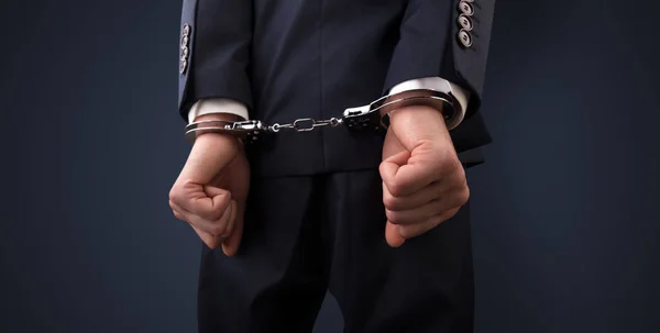 Dark backgrounded close handcuffed man — Stock Photo, Image