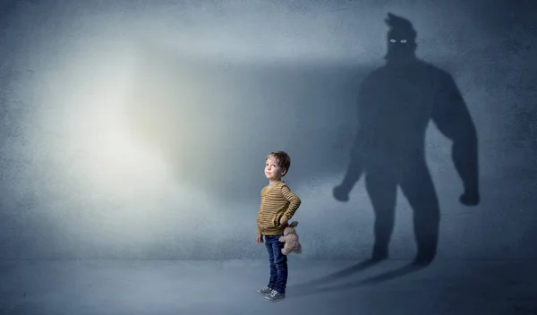 Cute kid with hero shadow behind — Stock Photo, Image