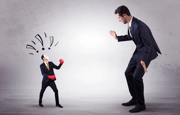 Businessman begging for small masked businessman — Stock Photo, Image