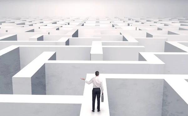 Small businessman in a middle of a maze — Stock Photo, Image