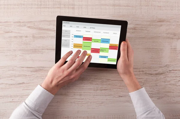 Hand holding tablet with timetable concept — Stock Photo, Image