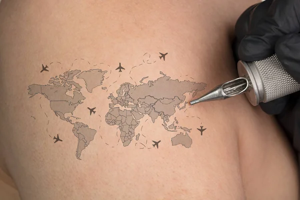 Tattooing traveling concept on naked back