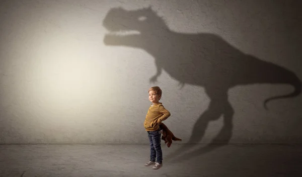 Dinosaurus shadow behind cute boy — Stock Photo, Image