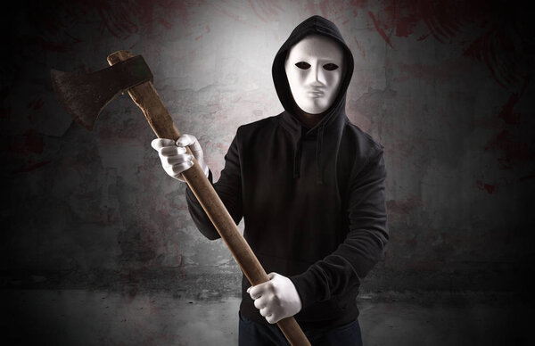 Armed assassin in an empty bloody room concept