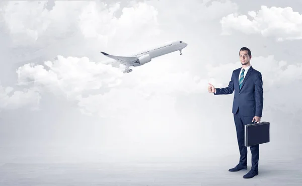 Agent hitchhiking with departing plane concept — Stock Photo, Image